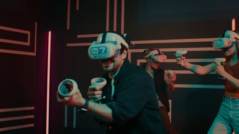 Two adults with VR headsets and game gear