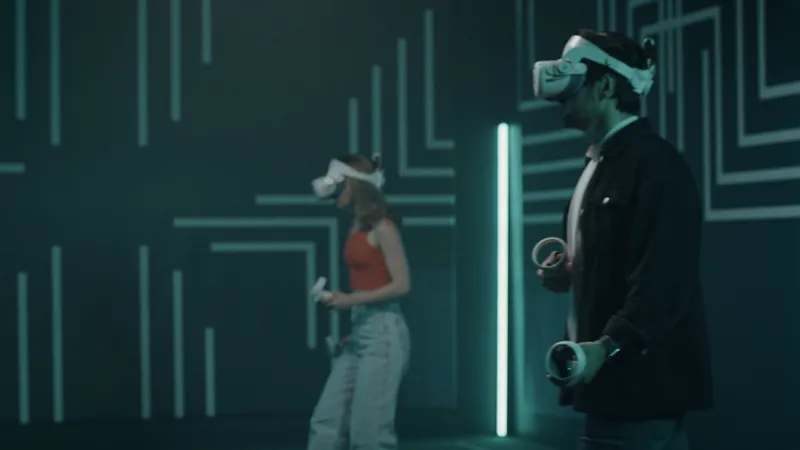 Three players with VR headsets and game gear